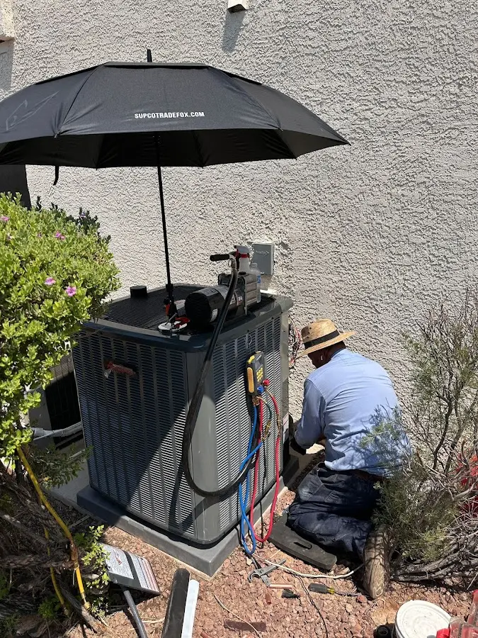 HVAC technician performing outdoor AC maintenance in Dunn Loring